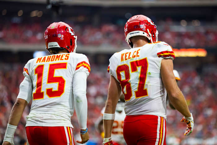 Patrick Mahomes and Travis Kelce walk onto the field during a Chiefs game